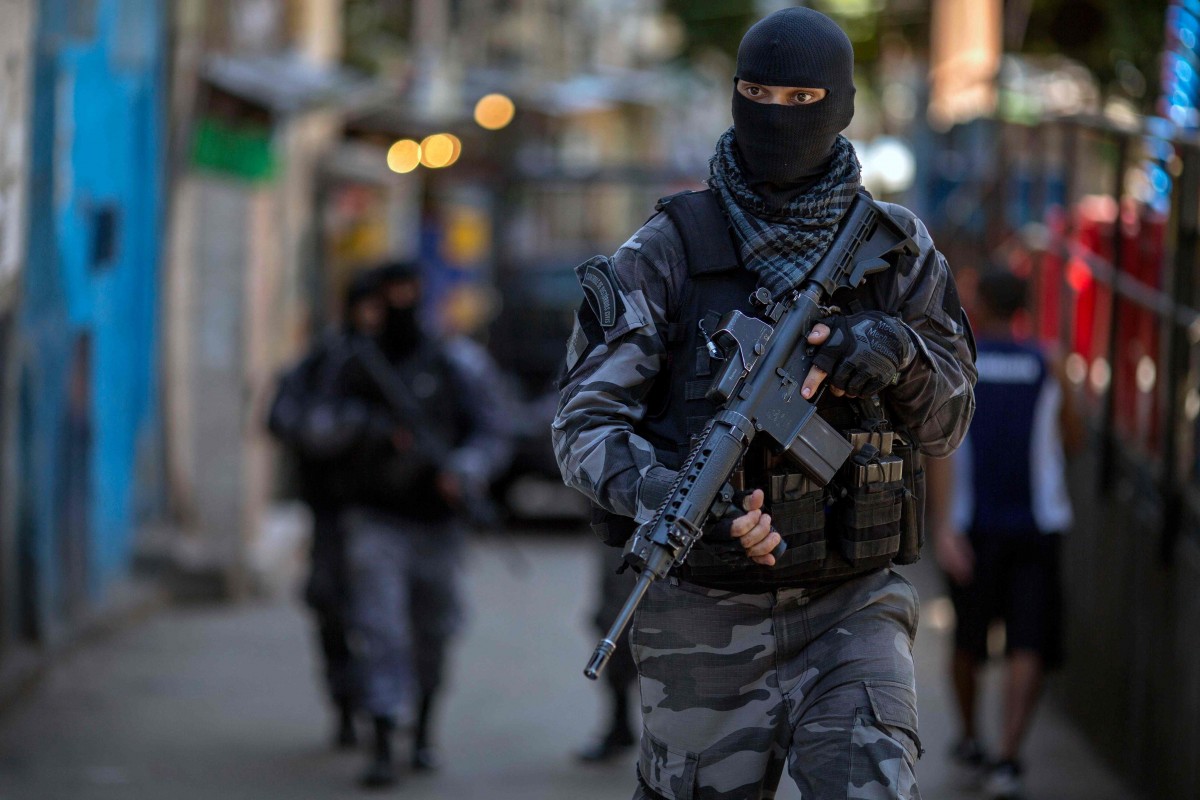IGOR VIDOR 16 Members of the Brazilian Military Police special unit Choque, patrol during an operation in the Rocinha favela in Rio de Janeiro, Brazil. Photo: AFP