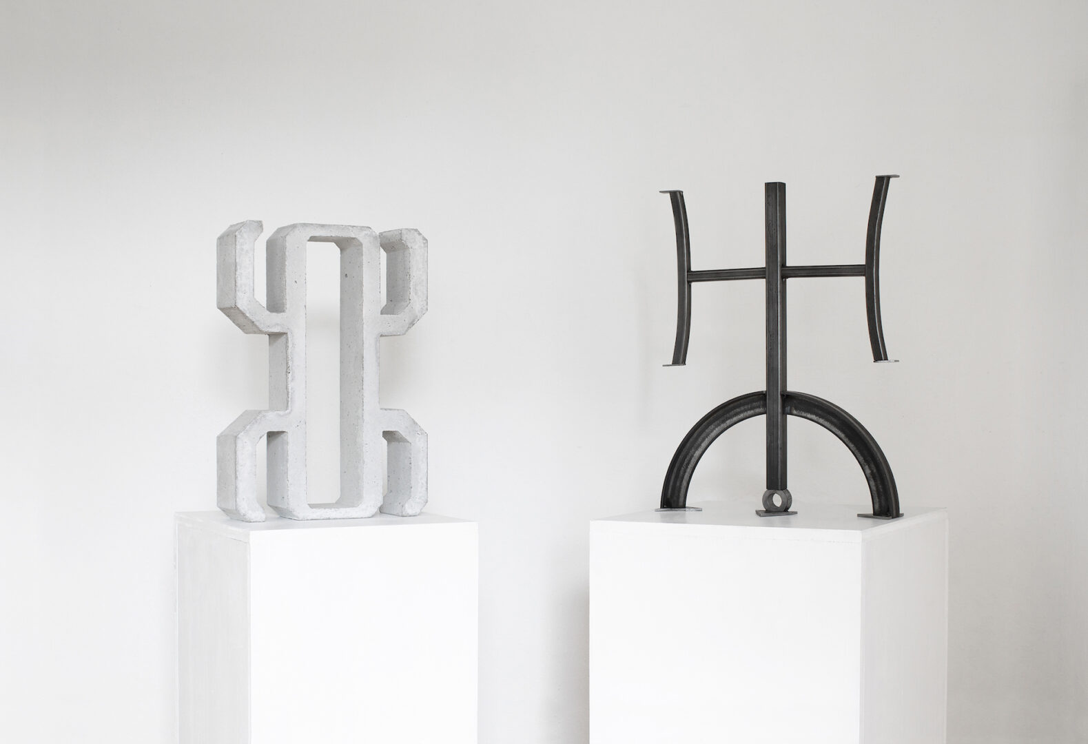 GØNEJA ✷ 8 Hieroglyph & Beyond The Naked Eye (2023), concrete / steel, 50 x 35 x 10 cm / 58 x 44 x 11 cm, A concrete artefact reinterpreting a prehistoric symbol that appeared throughout every continent. A planetary hieroglyph made of steel off-cuts inscribing the alchemical sigils of Neptune, Uranus and Pluto.